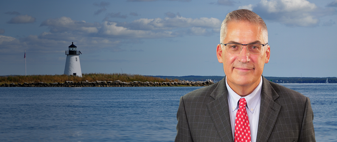 Attorney John C. Manoog, III with a lighthouse at the background