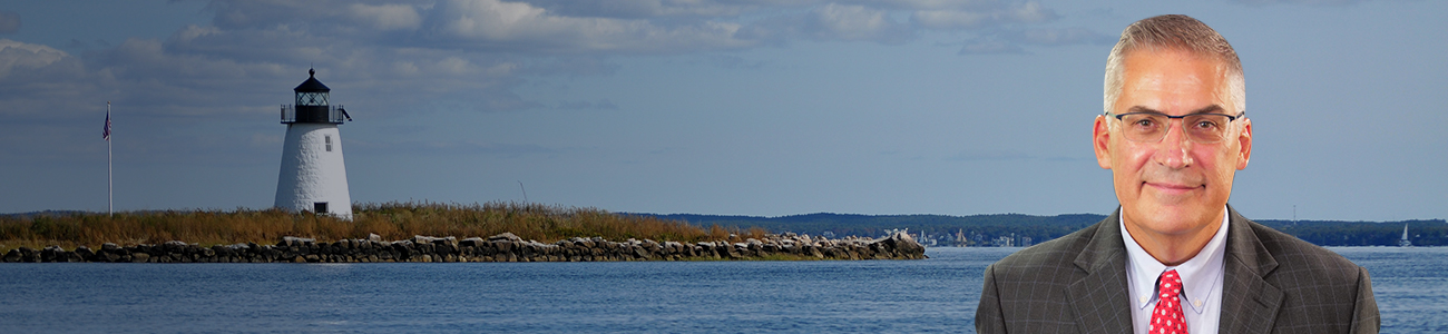 Attorney John C. Manoog, III with a lighthouse at the background