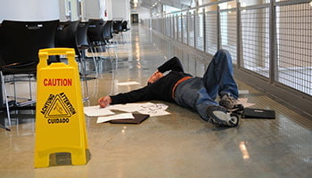 A man laying on the floor in an office building