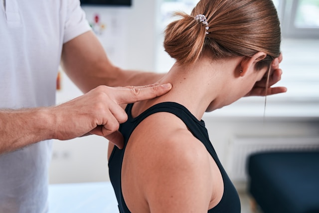 woman at doctor getting treatment for a neck injury